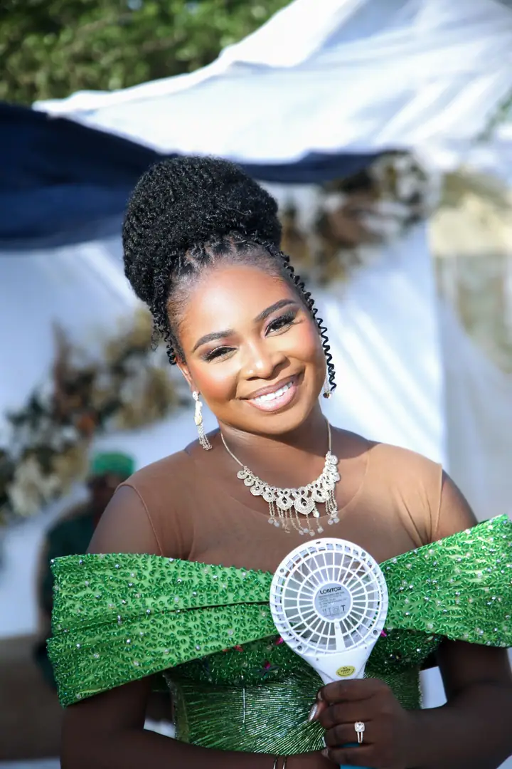 A smiling guest in green